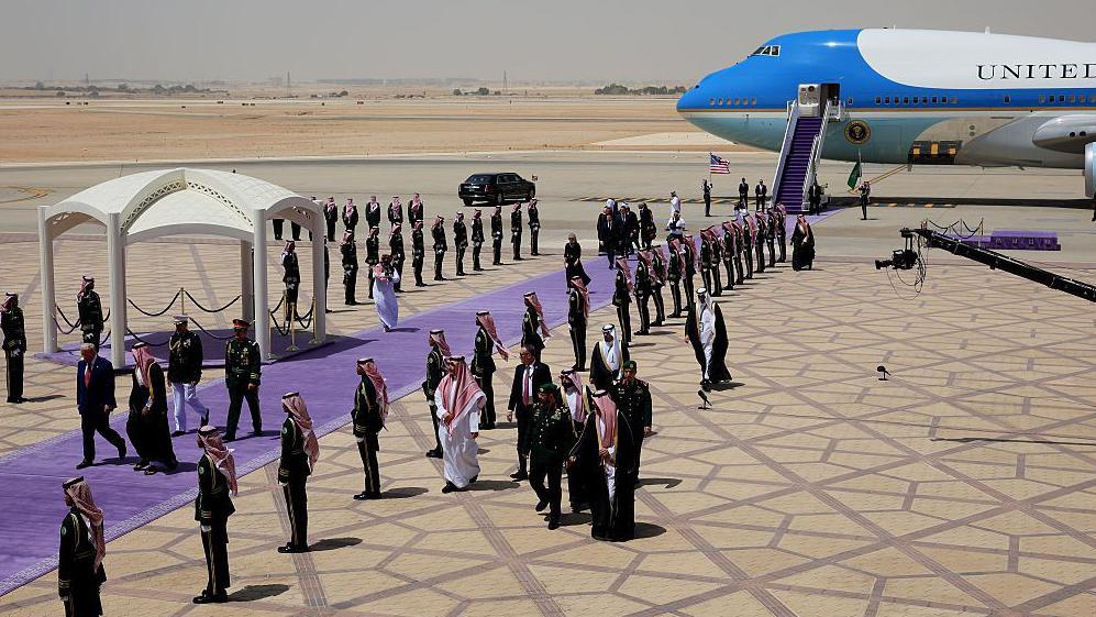 Trump walking through a guard of honour with Saudi Crown Prince Mohammed bin Salman upon landing in Riyadh