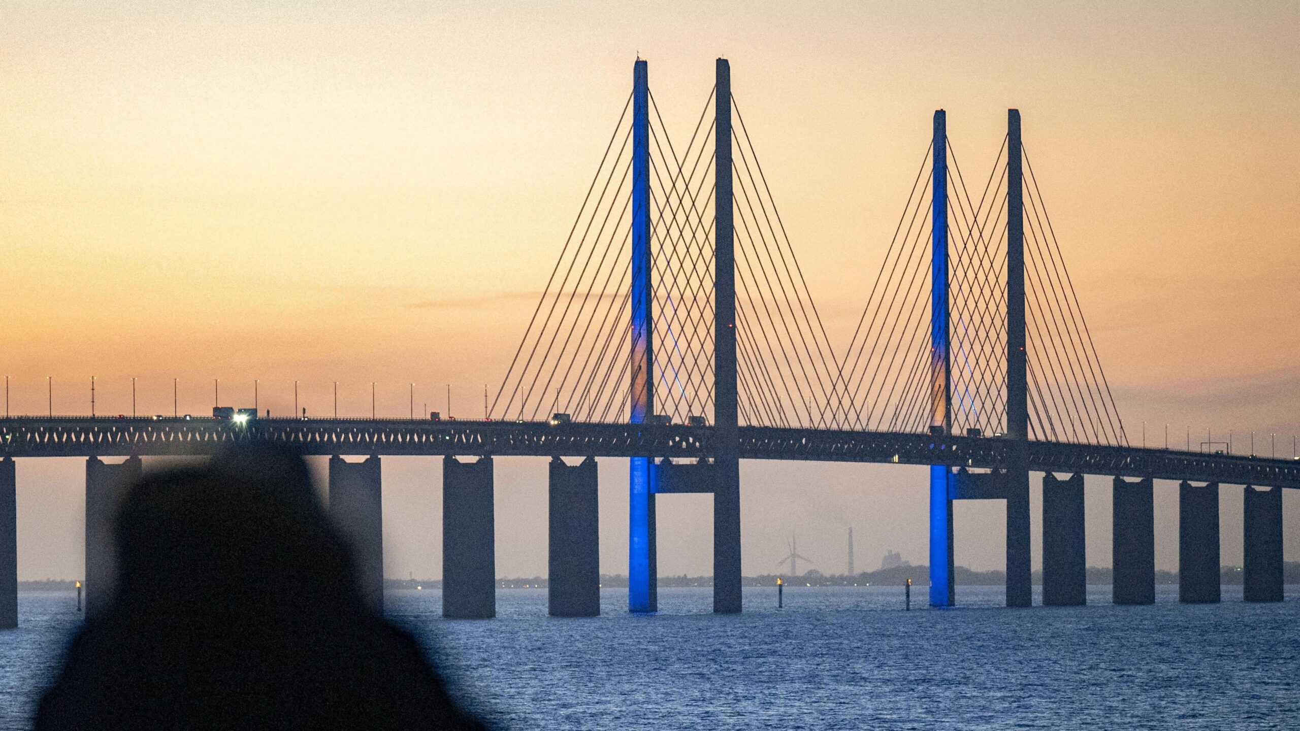 The Oresund Bridge lit up with the Swedish flag