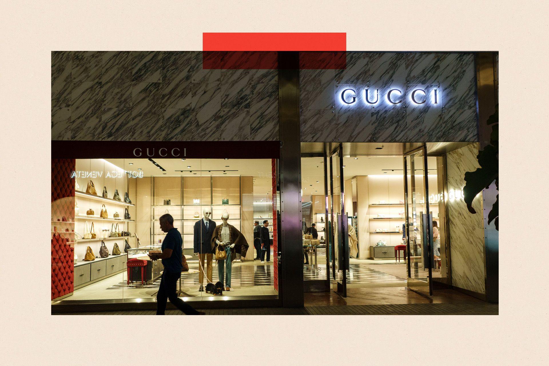 A shopper walks past a Gucci store in a shopping mall in San Diego