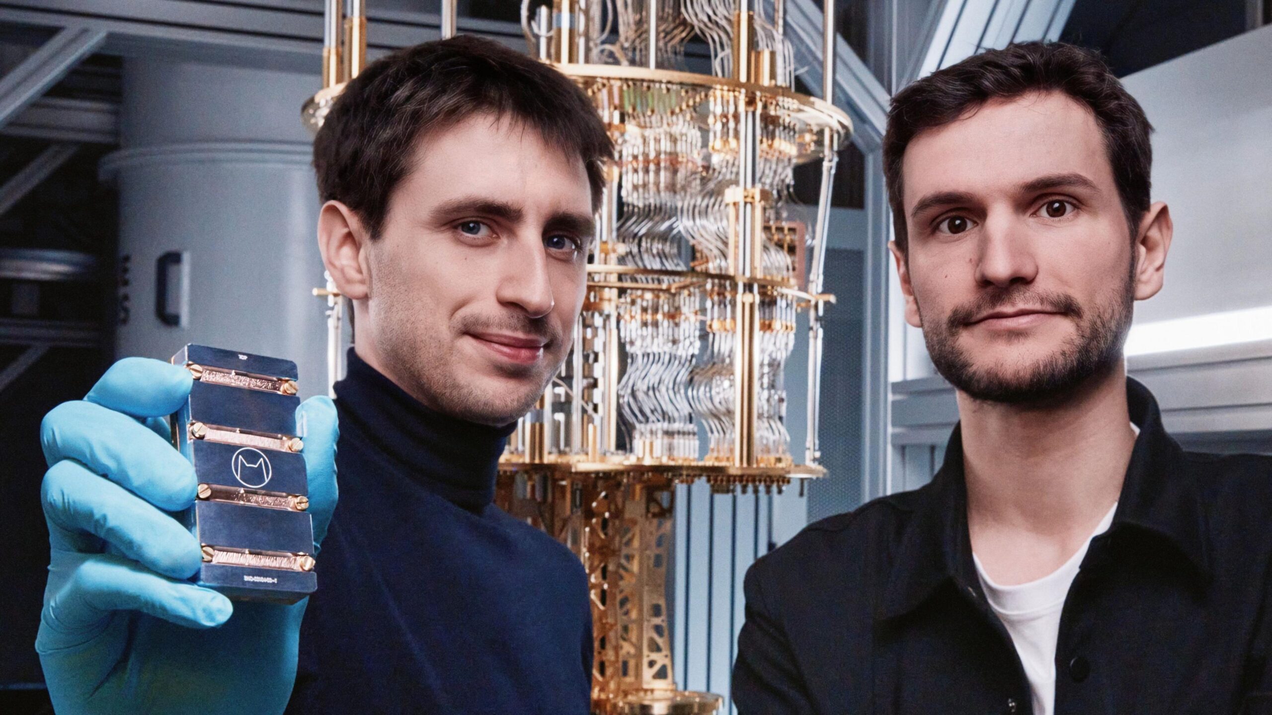 Théau Peronnin holds one of his company's computer chips and stands next to co-founder Raphaël Lescanne.